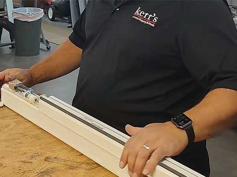 A man working on window coverings